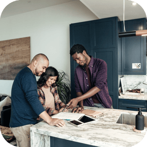 sales rep in kitchen with couple SQUARE